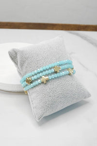 Mini Sideways Cross Bracelet stack Glass and gold metal beads: Light Blue